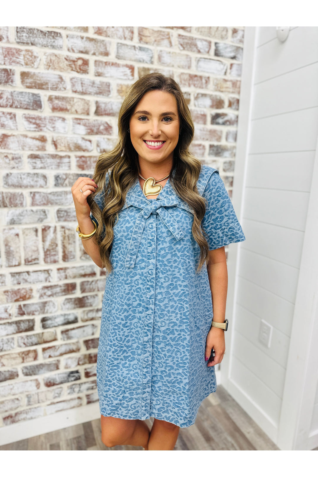 Woman wearing denim cheetah dress with bow detail
