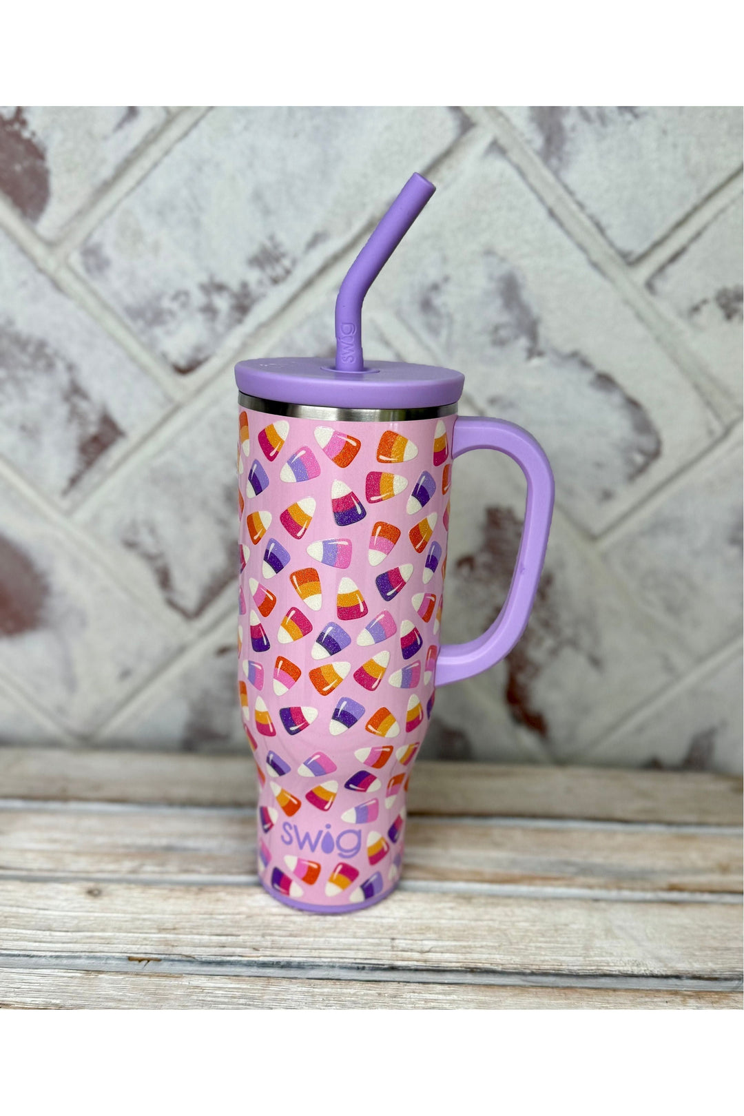 Swig Candy Corn Glow in the Dark Mega Mug 30oz. Purple lid, pink background with pink, orange, purple candy corn all over