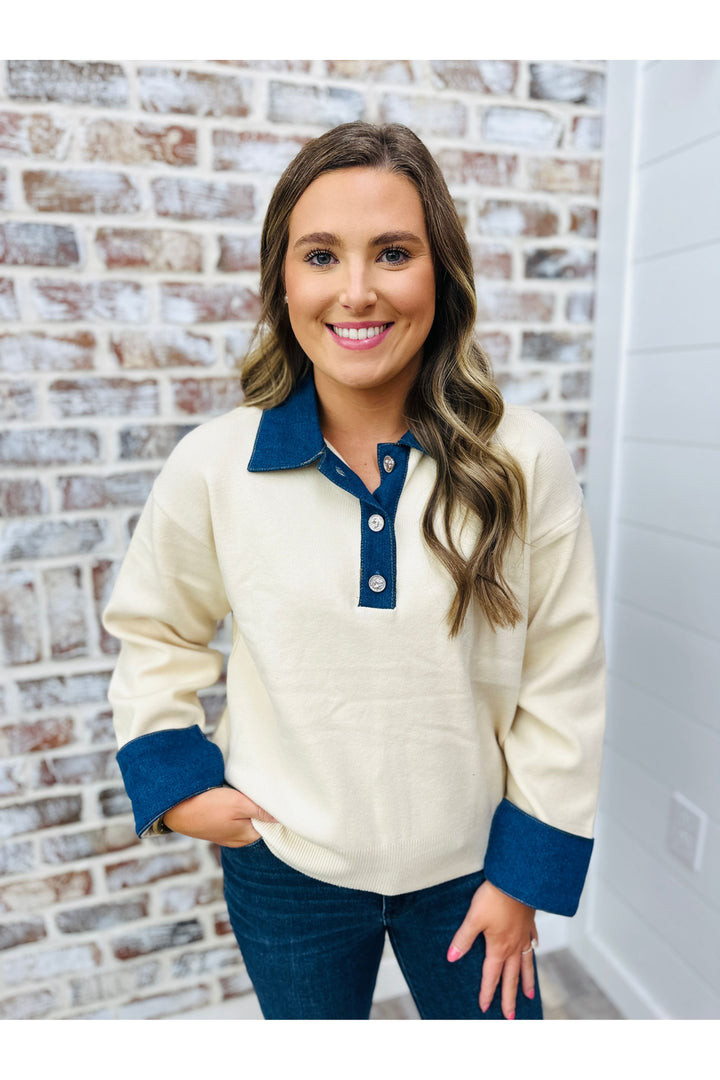 Cream top with button down 1/4.  Collar, button down area and sleeves have denim