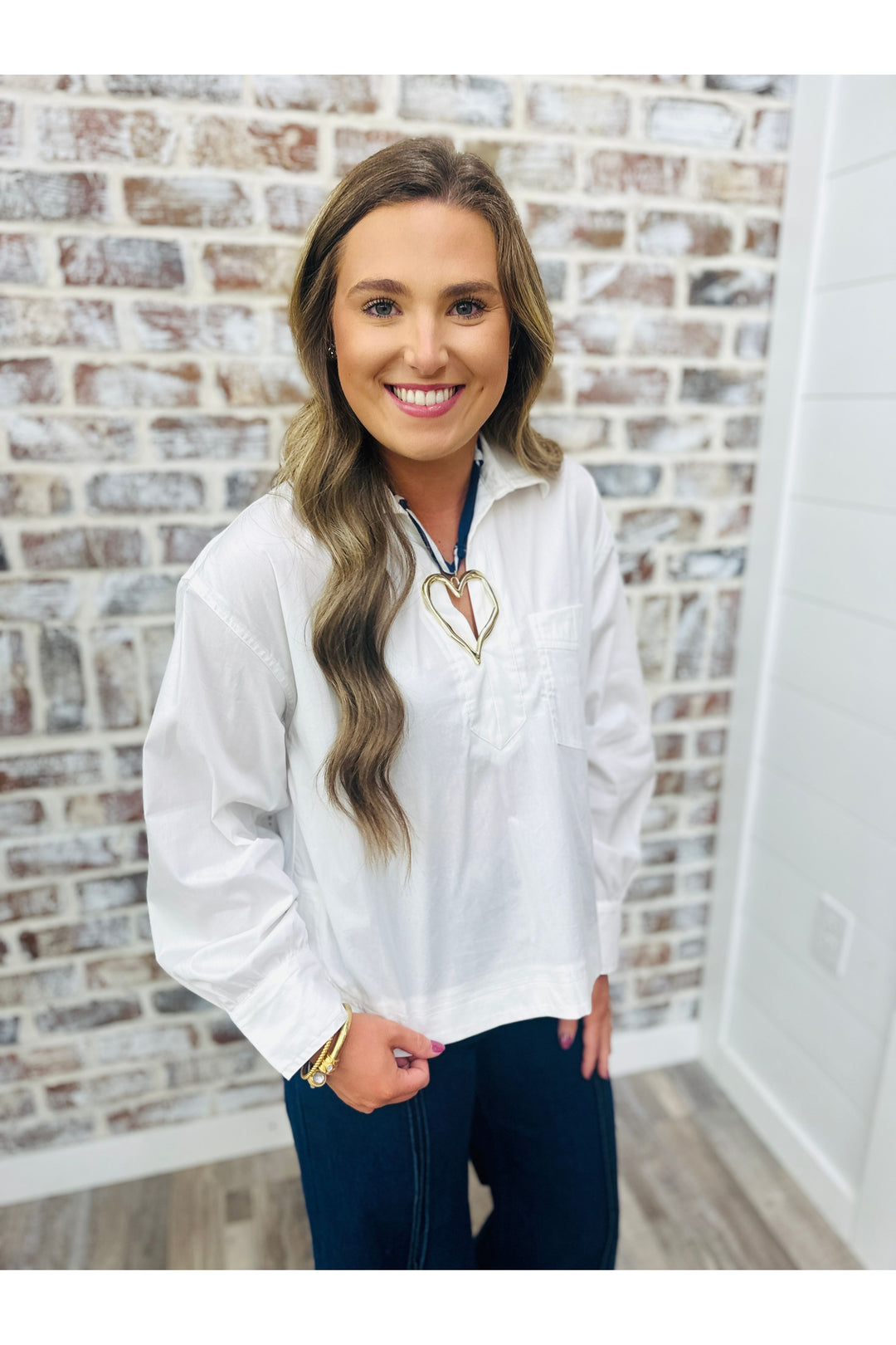 Woman wearing white oversized collar shirt with necklace 