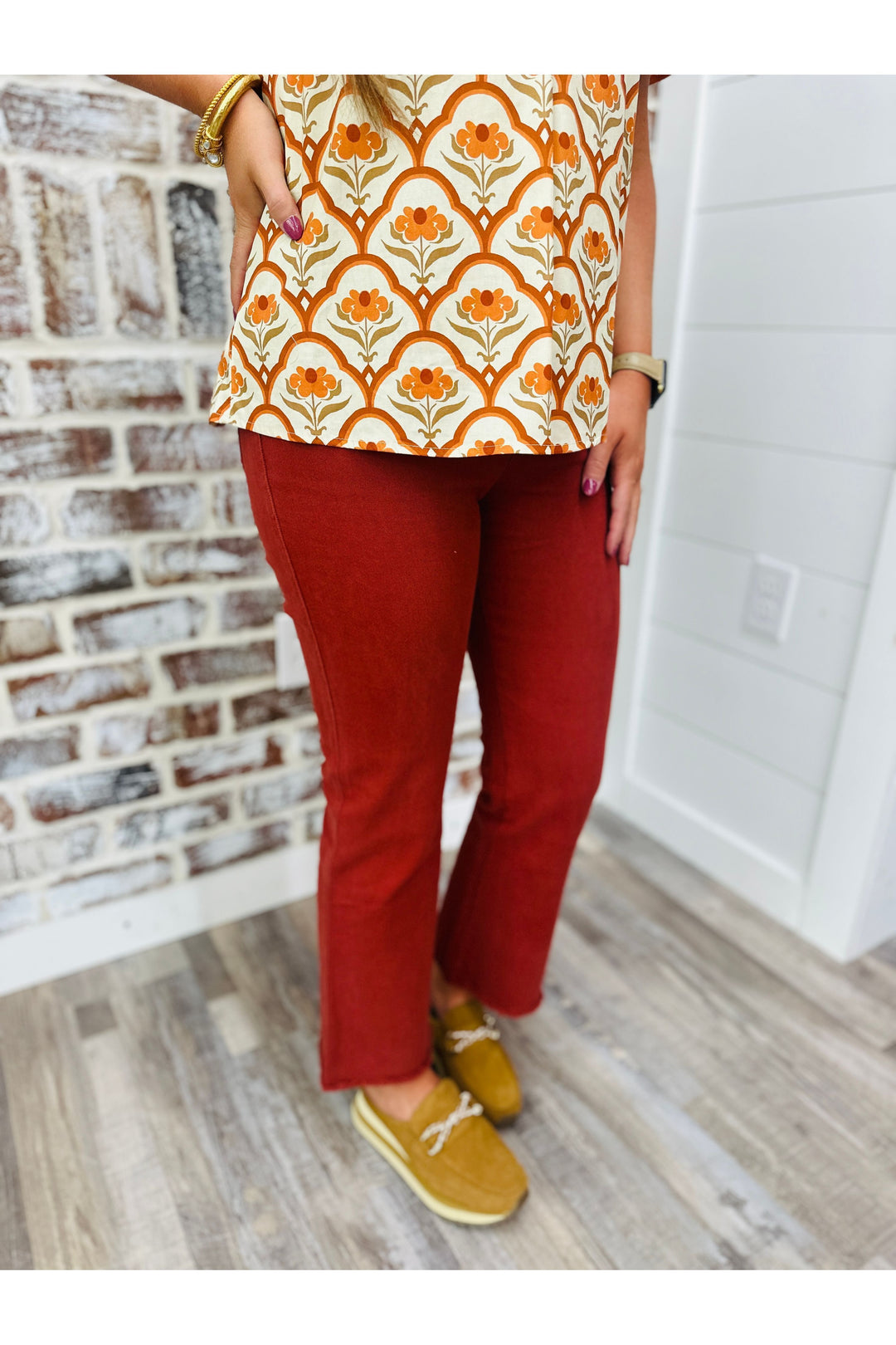 Women wearing rust high waisted flare pants 