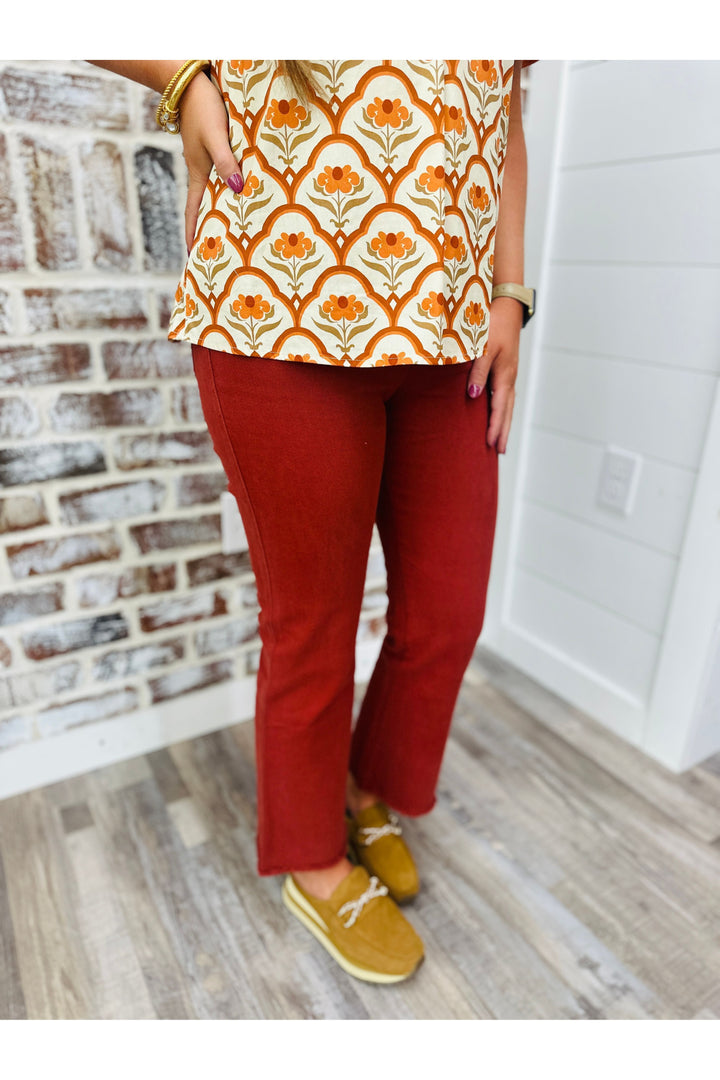 Women wearing rust high waisted flare pants 