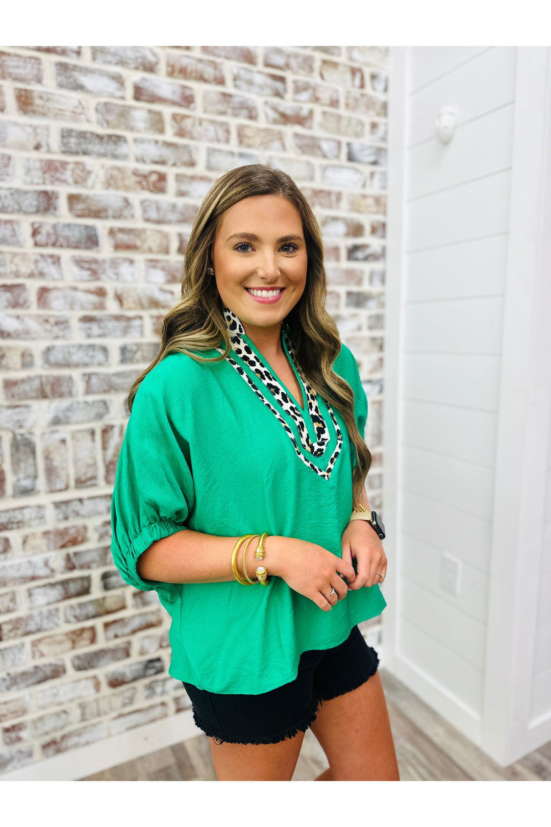 green short sleeve top with leopard design around v-neck line