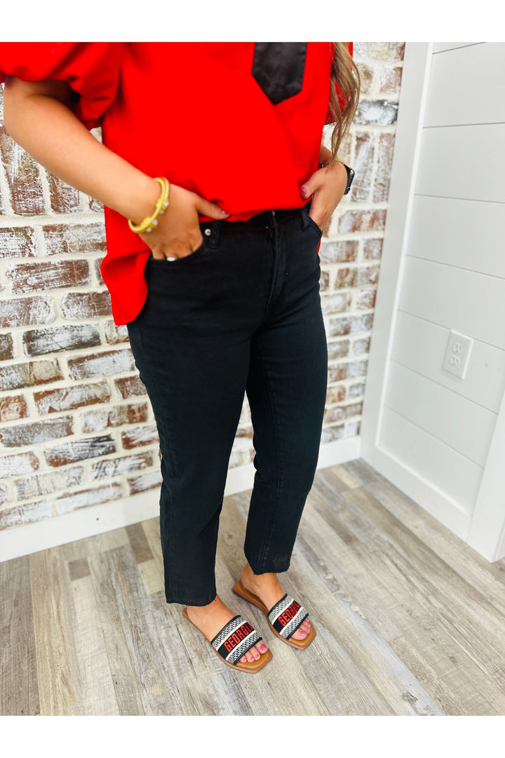 Woman wearing black straight leg high rise pants
