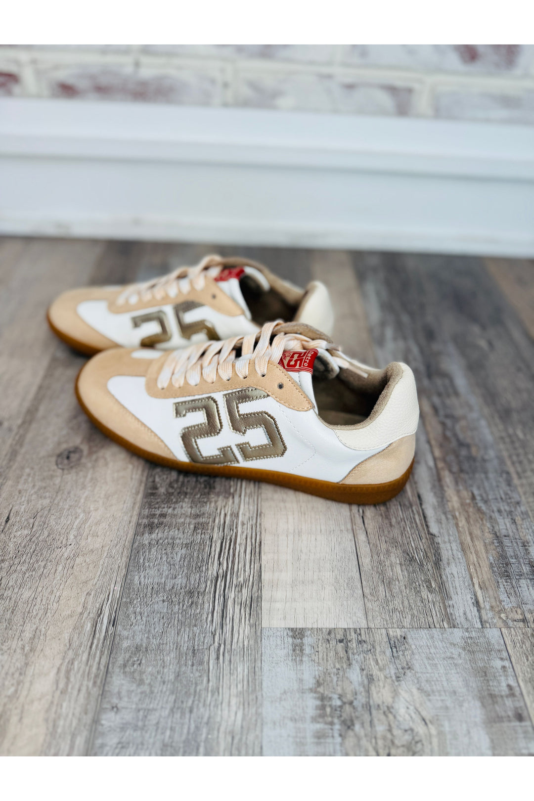 Cream and gold sneakers with metallic twenty five on side
