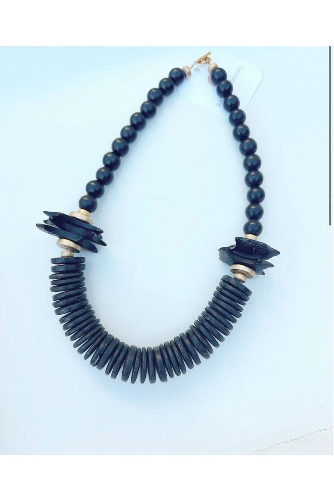 Necklace with Black coconut and wood beads.

Approximately 19”