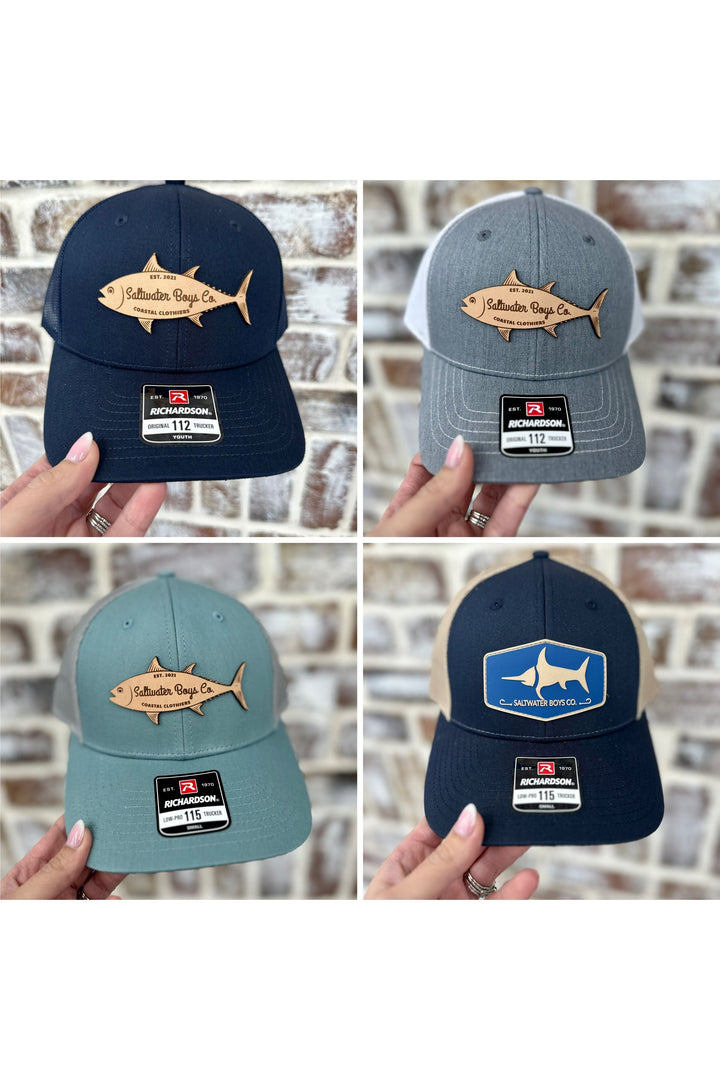 Youth Saltwater Boys Logo patch hat available in navy, grey, mint, and navy with blue.