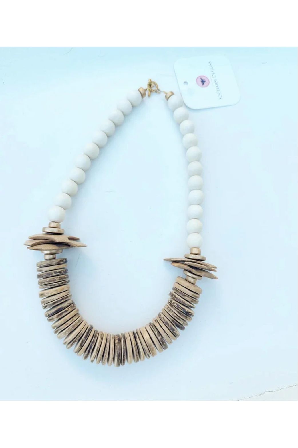 Necklace Made with brown and white coconut and wood beads.

Approximately 19”