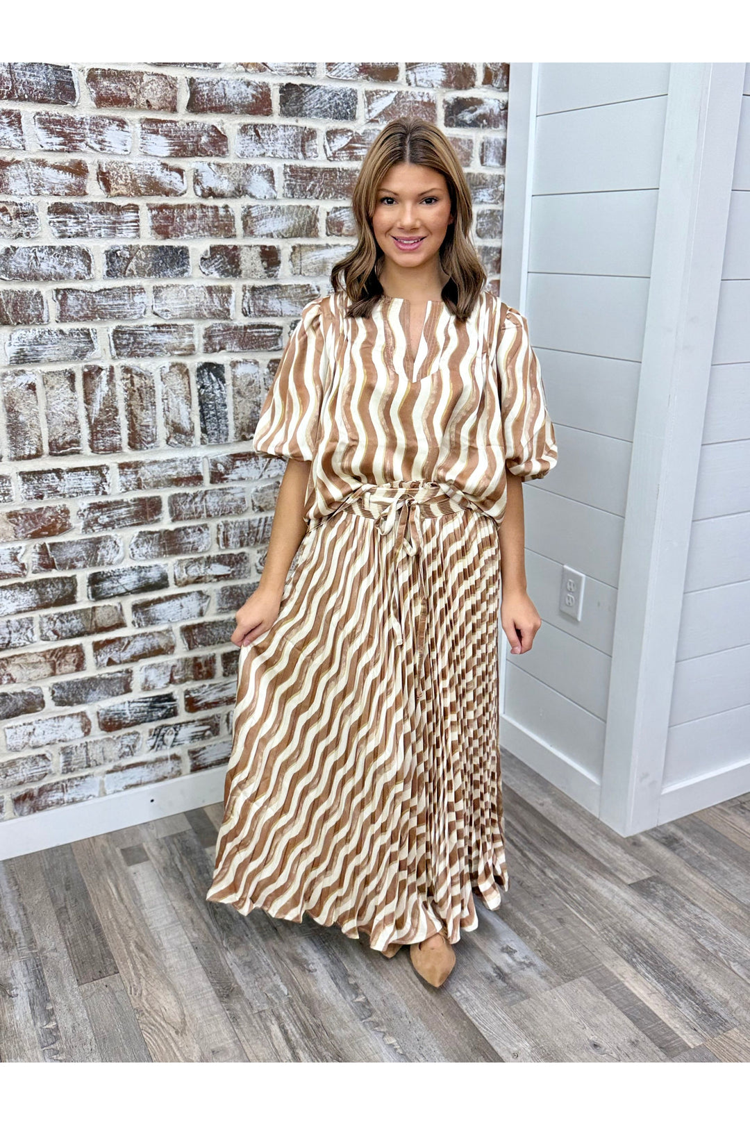 Top and maxi skirt set with wavy design in colors of beige and tan. 