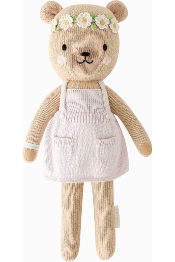 13 inch stuffed honey bear toy with a pink dress and pockets on the front. 