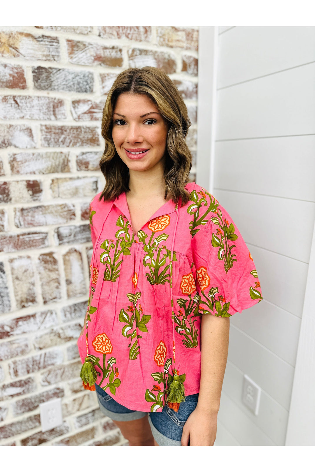 pink short sleeve tassel top with flower details