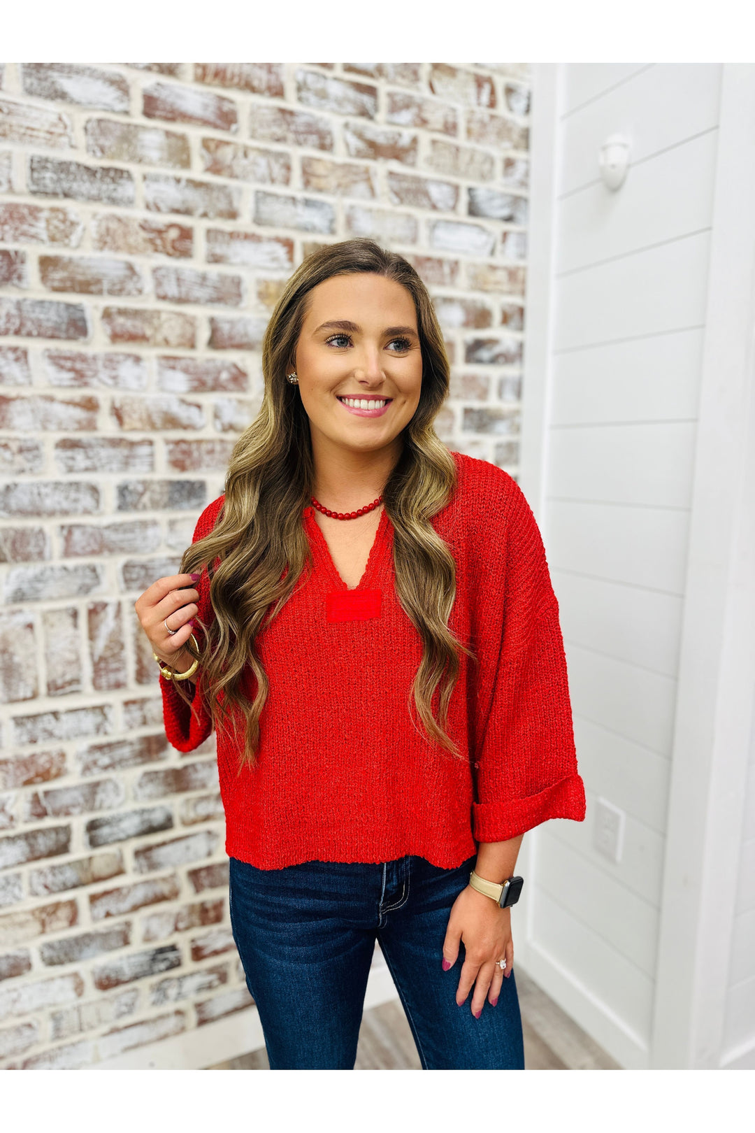 Woman wearing red cropped v neck sweater top in red 