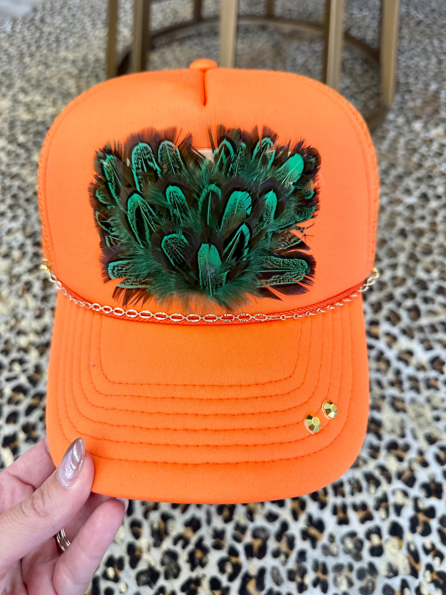 Orange Trucker Hat with Green Feathers