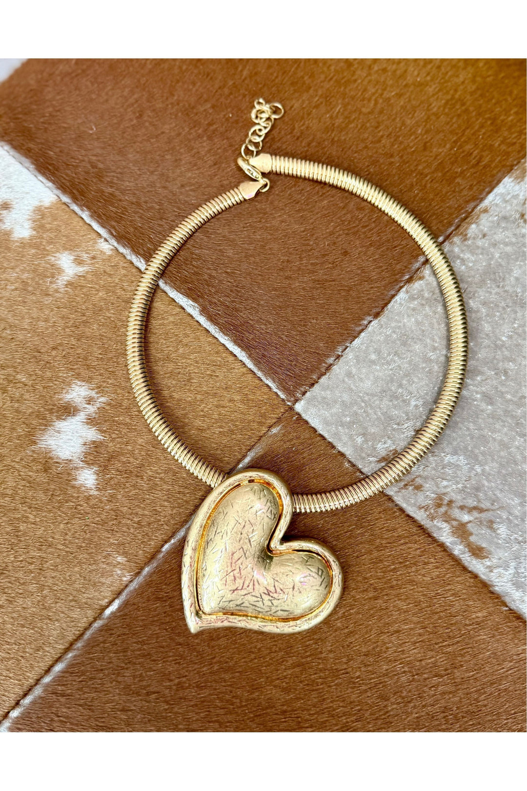 Big heart charm on gold necklace