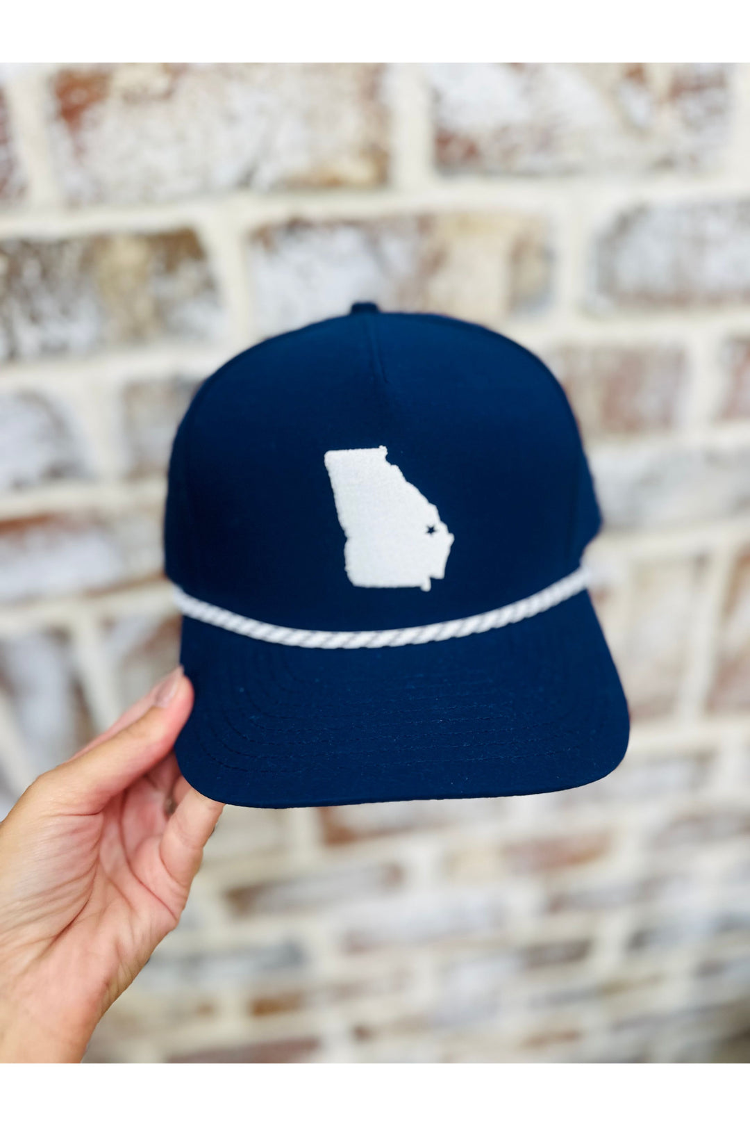 Navy hat with white Georgia symbol and white rope detail.