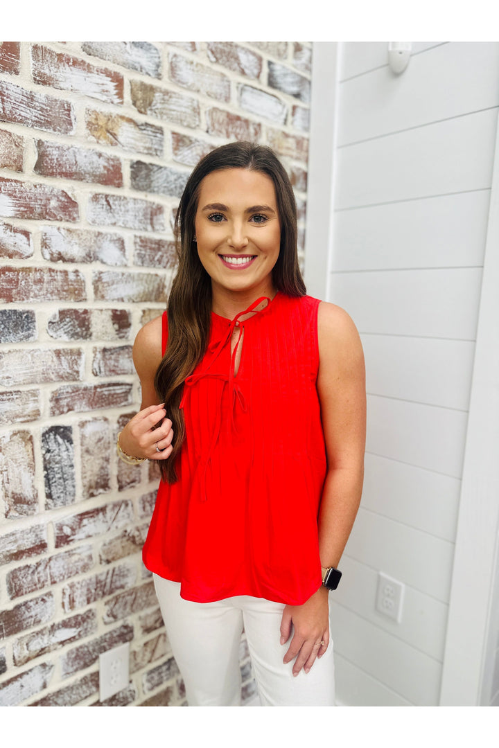 sleeveless red top, two bows that tie at v-neck