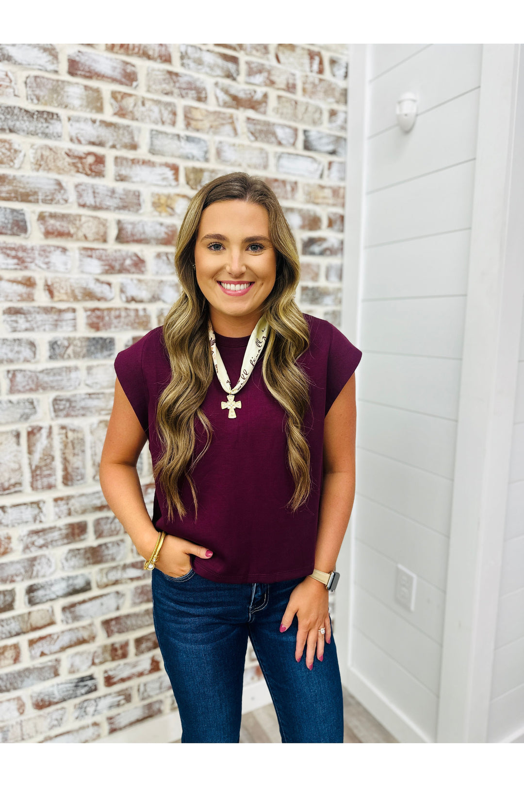 Woman wearing Merlot colored shirt with necklace 