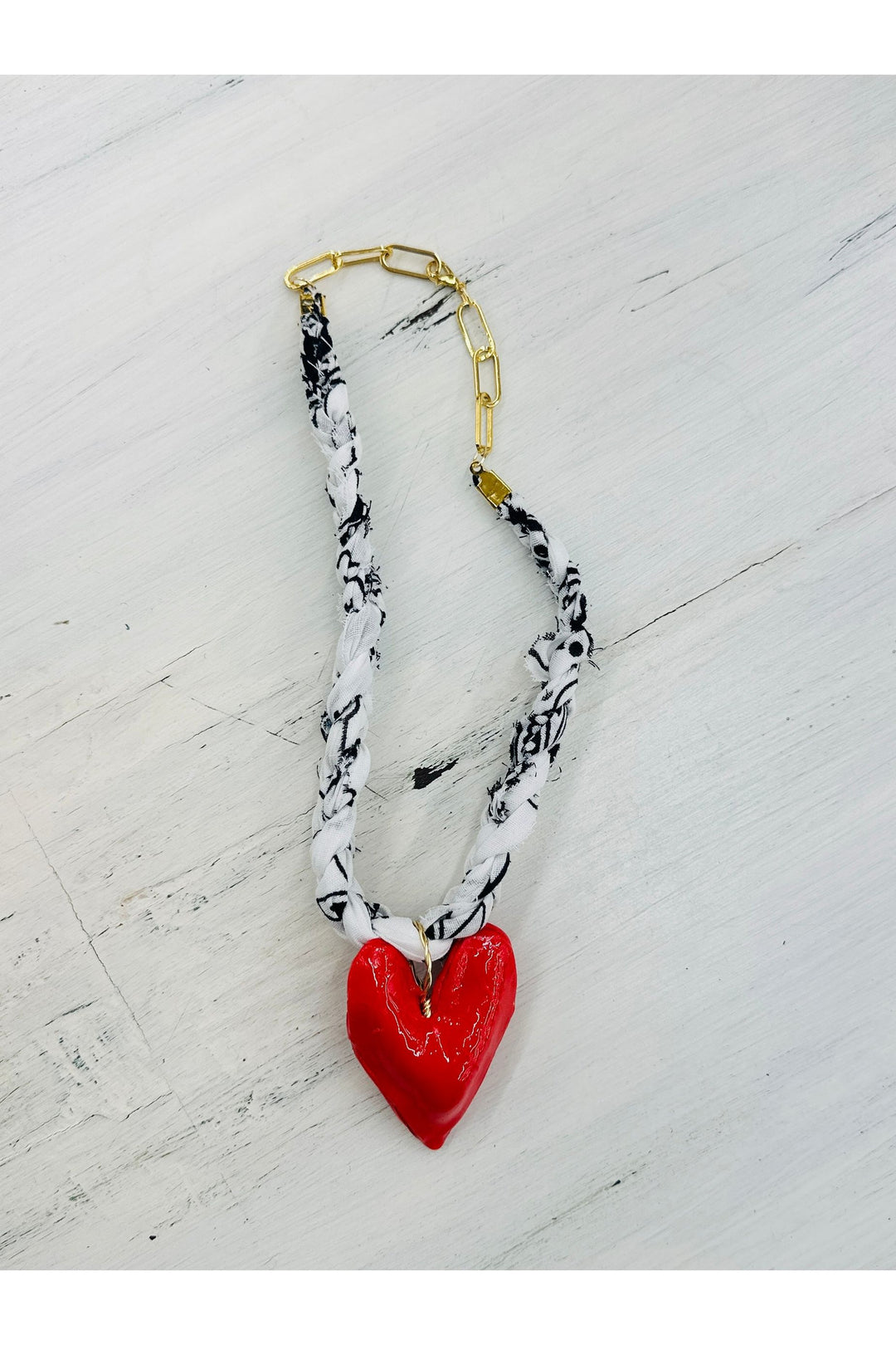 black and white braided scarf necklace with red heart charm. 