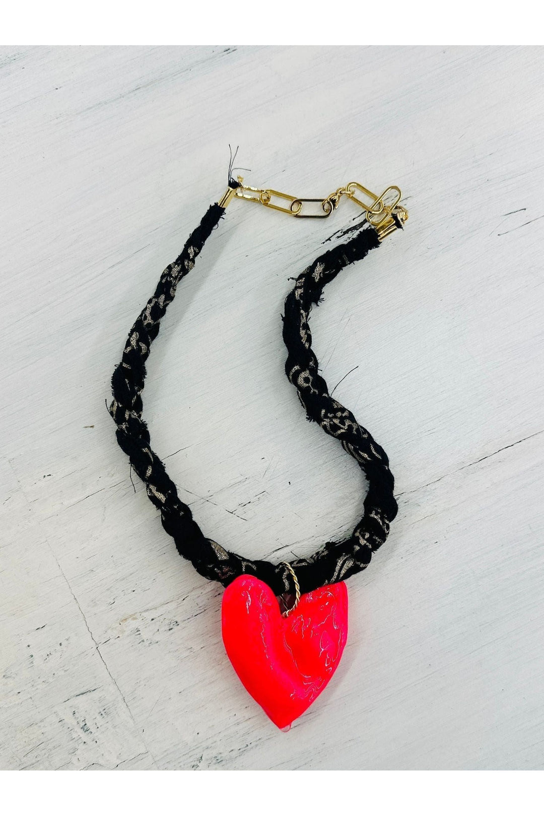 Black and gold braided scarf necklace with hot pink heart charm.