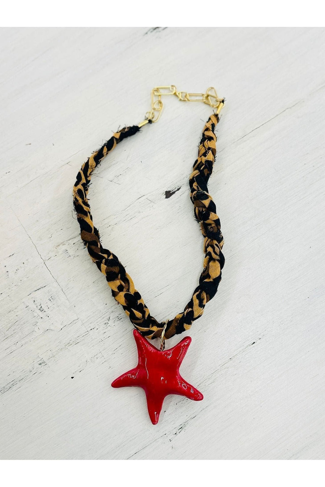 Leopard braided scarf necklace with red star charm.