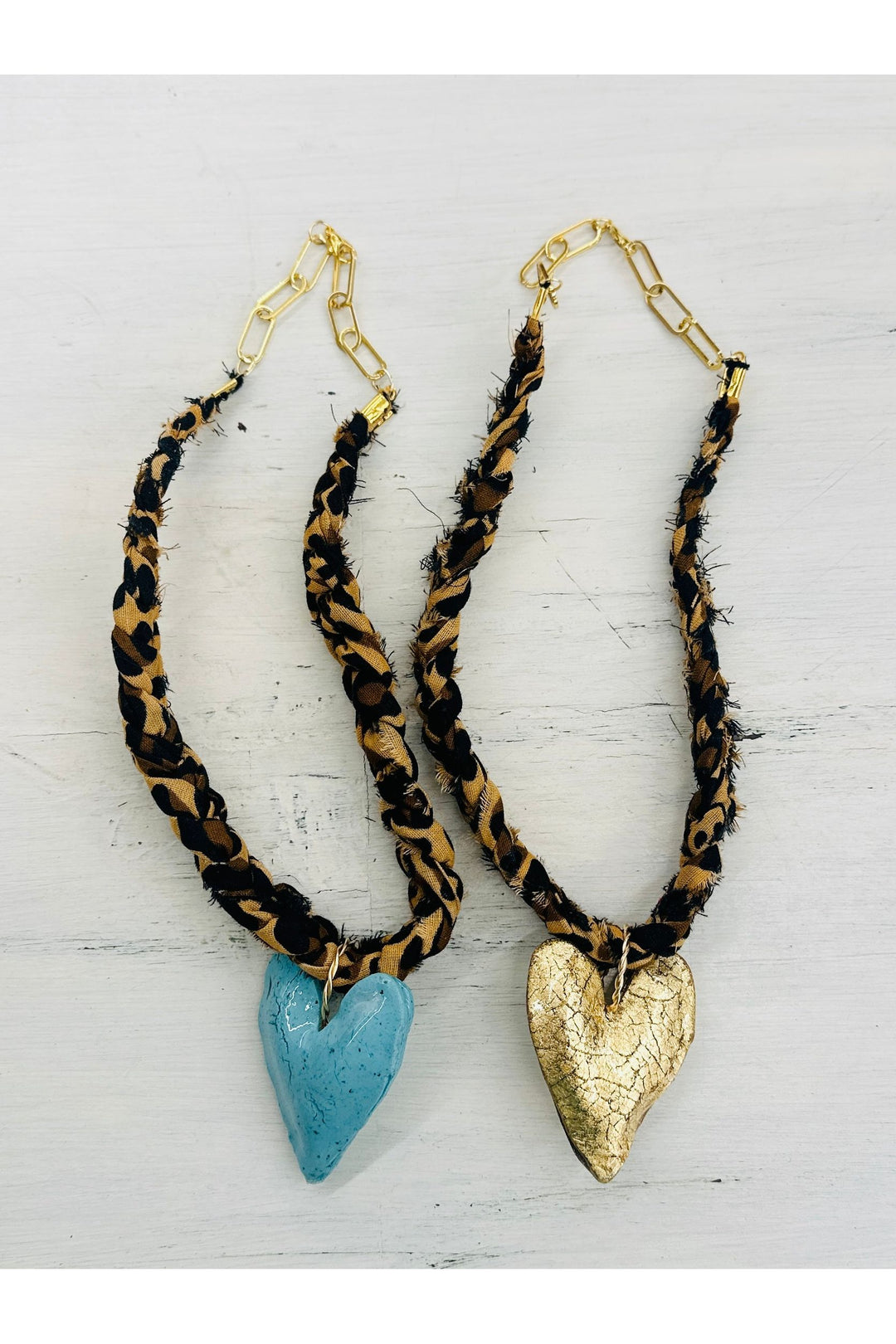 Leopard print scarf necklaces with turquoise and gold chunky hearts. Gold adjustable clasps on the back.