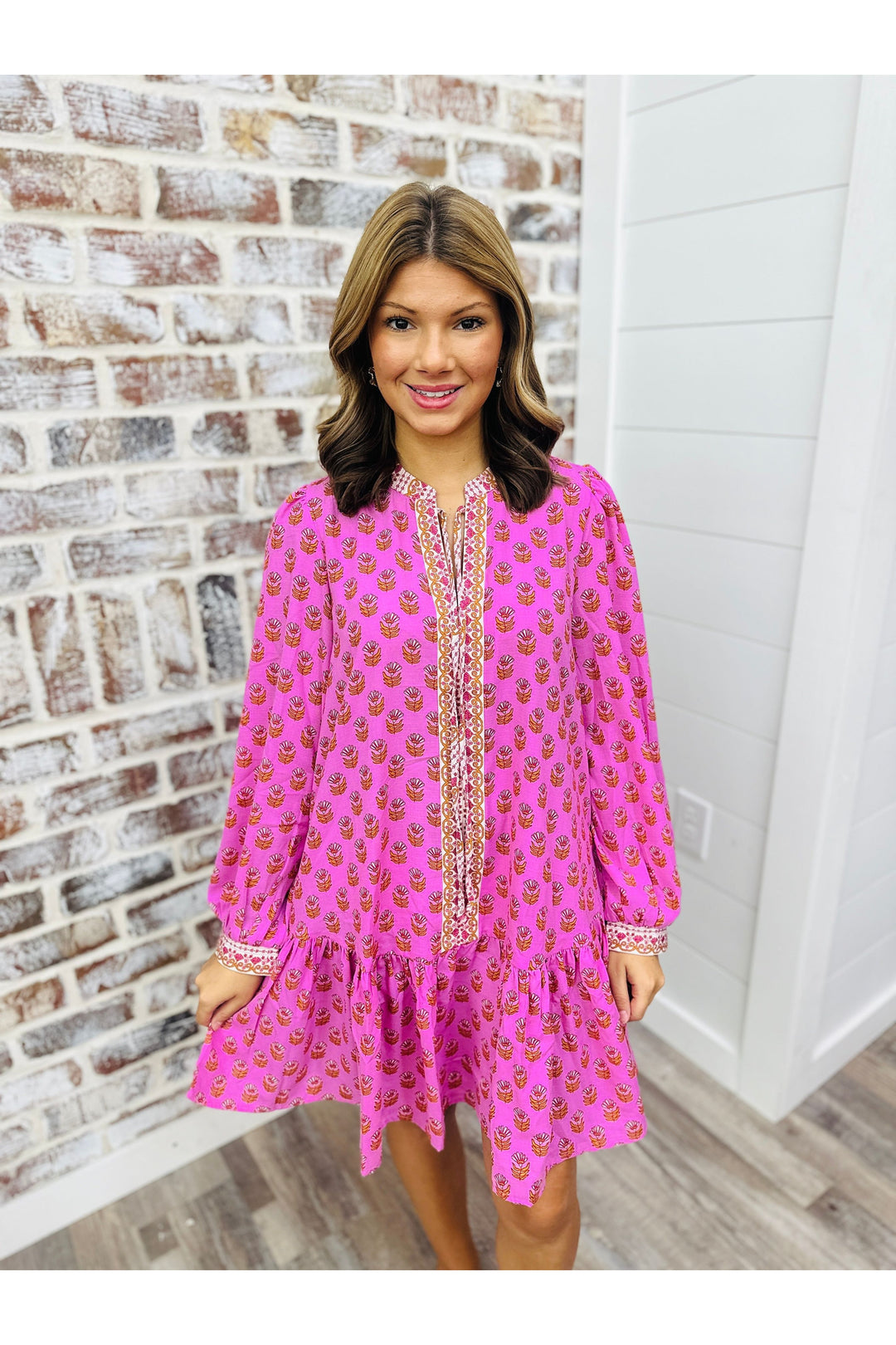 Women wearing magenta dress with floral detail