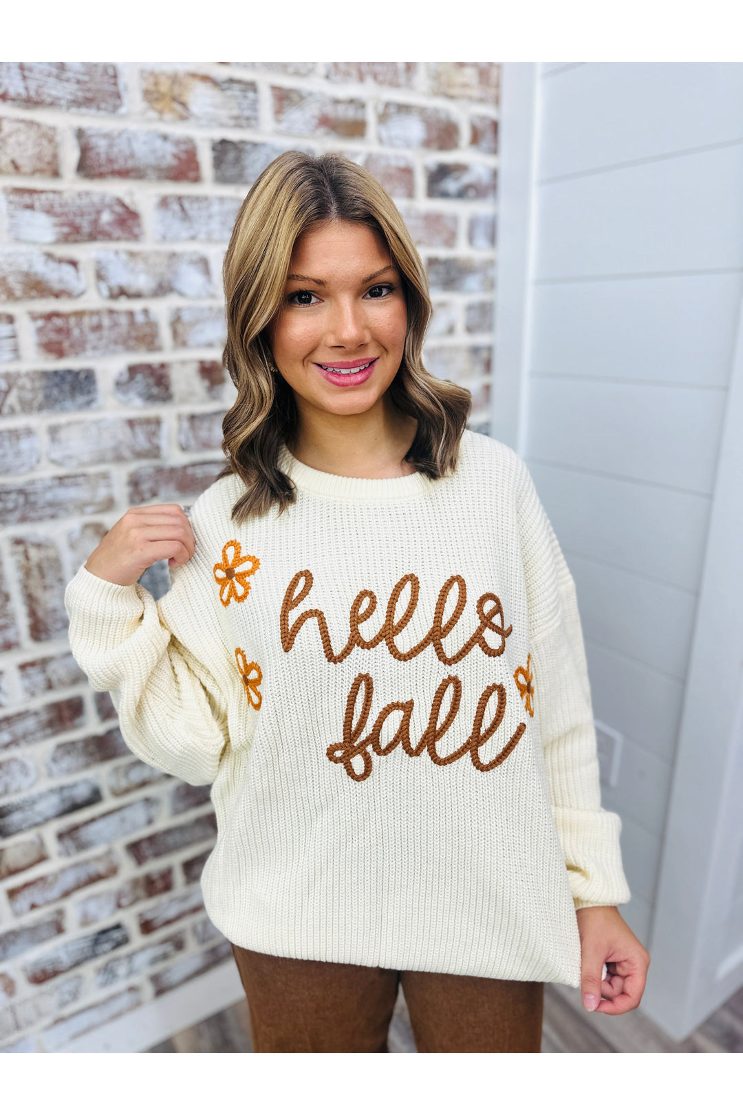 knit sweater in a cream, embroidered flowers and “hello fall” lettering