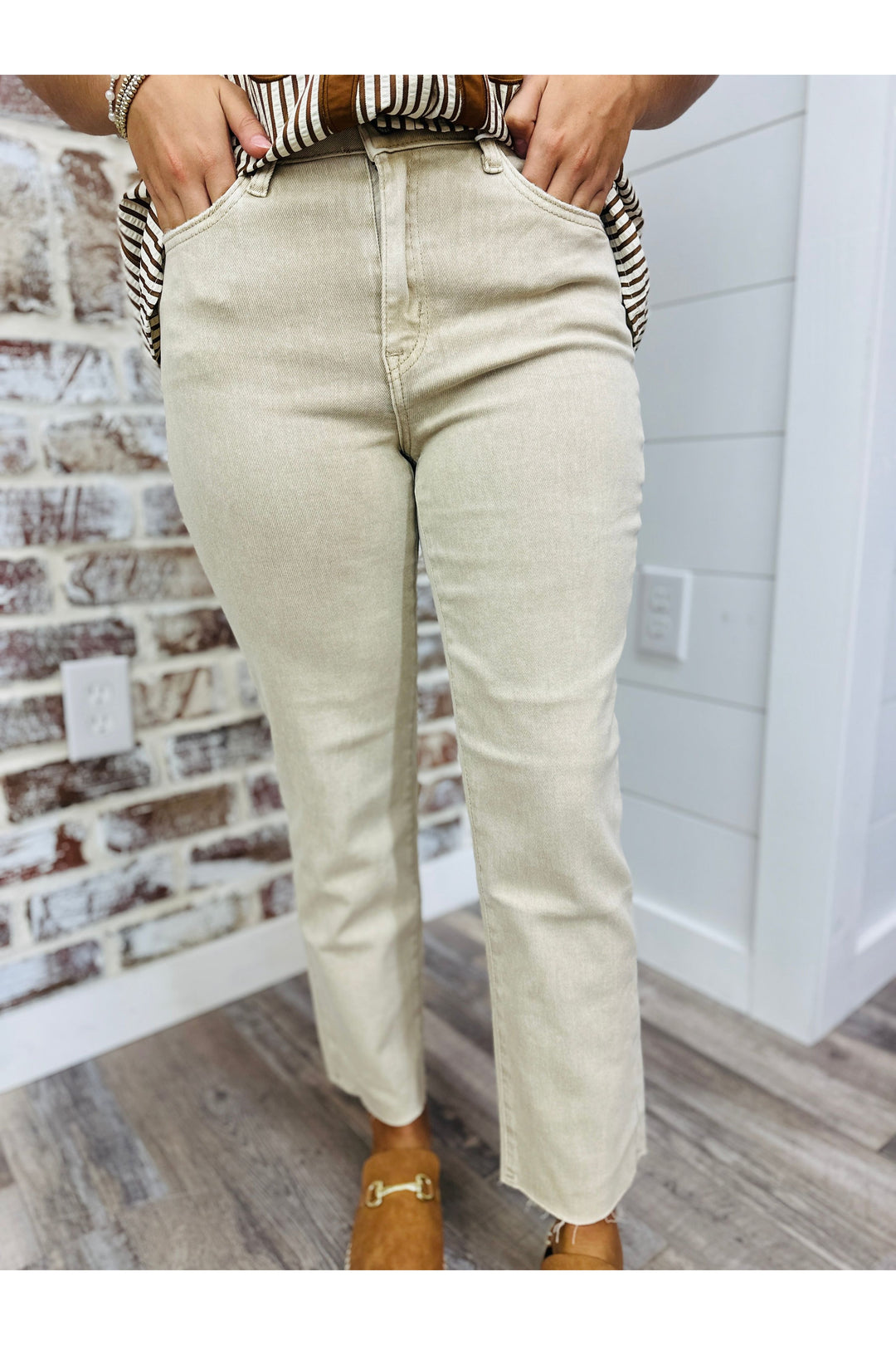 Woman wearing sand beige high rise straight jeans