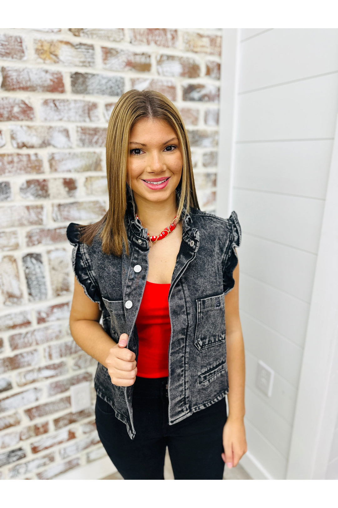 Black ruffle denim jacket with ruffle detail on sleeves.